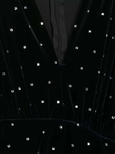 Close-up of velvet midi dress featuring V-neckline and square silver stud embellishments