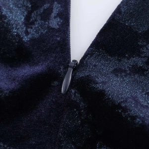 Close-up of the high-quality invisible zipper on a deep blue velvet maxi dress