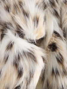 Macro view of luxurious faux fur fabric with animal spots on soft plush winter coat