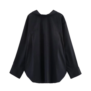 Detail of loose black long-sleeve shirt with drop shoulders and curved hem on white background
