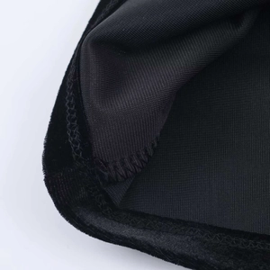 Detail of elegant black velvet dress showing seam stitching and soft fabric texture