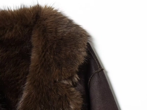 Detail of soft brown fur collar and premium suede texture on a stylish winter jacket