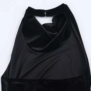 Elegant backless black velvet dress featuring a stylish halter neck design with back button