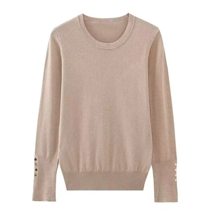 Elegant slim fit crewneck knit sweater with decorative gold buttons on cuffs in beige
