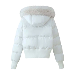 Detail view of white puffer coat featuring a plush faux fur hood and ribbed hem details