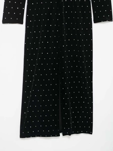 Detailed view of black velvet fabric with silver square rhinestones in grid pattern