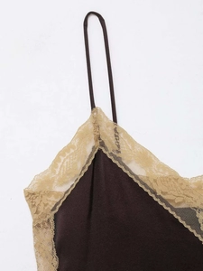 Close-up of elegant dark brown satin camisole set with gold lace trim and fine straps