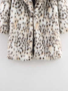 Detail of soft leopard print faux fur coat with oversized lapels and fluffy plush texture