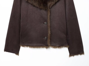 Close-up of brown suede jacket showing plush faux fur collar and textured fabric detail