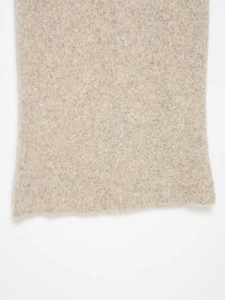 Detailed macro view of the minimalist oatmeal knitted fabric with soft wool texture