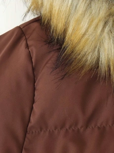 Detail of brown hooded parka showing matte fabric texture and fluffy faux fur collar