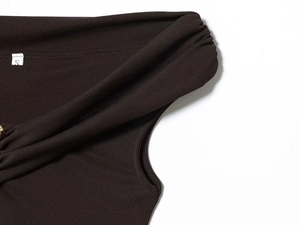 Detailed view of the shoulder twist design on this dark brown sleeveless maxi dress