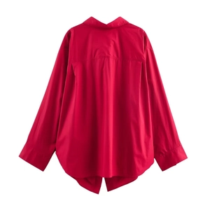 Back view of a red long sleeve shirt featuring back pleats and a curved high-low hemline