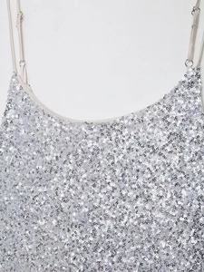 Détail de la robe à paillettes argentées avec fines bretelles réglables et éclat métal
