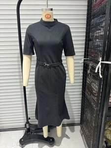 Detail view of a slim-fit dark grey midi dress with a high neck and matching waist belt