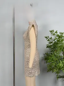 Side view of champagne gold sequined slim fit cocktail dress on a mannequin