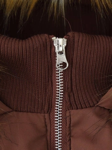 Detail of silver zipper and brown faux fur collar on winter hooded jacket