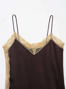 Close-up of elegant V-neck camisole with delicate beige lace trim and silk texture
