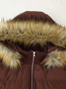 Detail of winter parka with fluffy faux fur hood and silver metal zipper closure