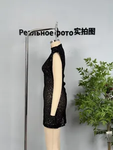 Side view of black sequin sleeveless bodycon dress with reflective party texture