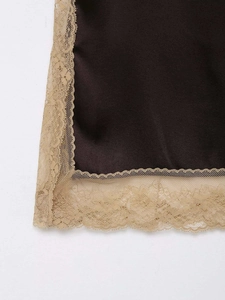 Close-up detail of smooth brown satin fabric with delicate beige lace trim and fine stitching