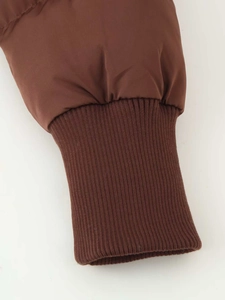 Detailed close-up of dark brown ribbed knit cuffs on a winter padded windproof jacket