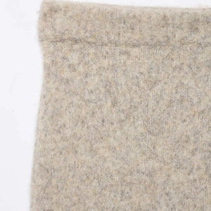 Close-up of minimalist oatmeal knit high waist midi skirt showing premium wool texture
