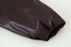 Detail of deep brown faux leather jacket featuring elastic gathered cuffs and fine texture
