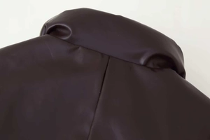 Close-up of brown faux leather collar with fine stitching on winter padded jacket
