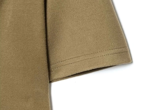 Detailed close-up showing the professional double-needle stitching on khaki twill fabric