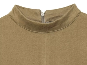 Detail of khaki mock neck dress featuring high-quality twill fabric and a silver H zipper