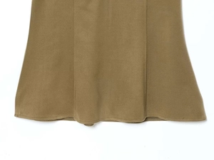 Detail view of khaki dress hemline showing high-quality stitching and A-line drape
