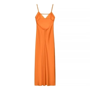 Detail of a vibrant orange satin midi dress featuring thin straps and backless design