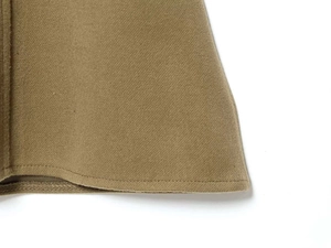 Macro detail of khaki twill fabric hem with clean stitching and reinforced inner binding
