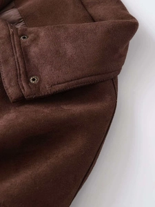 Detail shot of the dark brown faux suede jacket featuring vintage metal snap buttons