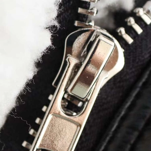 Women's winter lapel jacket with silver zipper and white faux shearling lining details