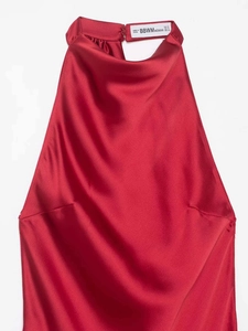 Detail view of the red satin halter neck top showing the brand label and smooth texture