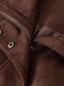 Close-up of vintage brown faux suede jacket featuring star-patterned buttons and metal zipper