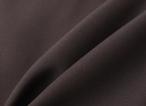 Close-up of deep brown twill weave fabric texture with premium matte finish for suits