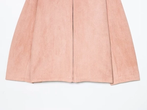Detail of pink suede jacket featuring high-quality fabric texture and central metal zipper