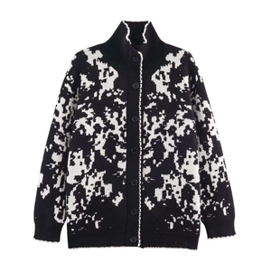 Loose knit cardigan with black and white abstract pattern and high collar design