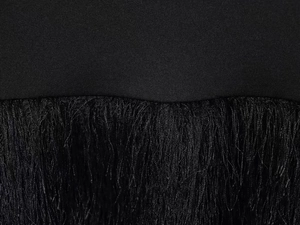 Close-up of black fringe detail and knit fabric stitching on a slim dress