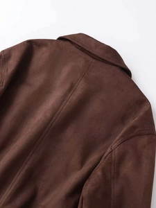 Detail view of dark brown faux suede jacket featuring precision stitching and matte texture
