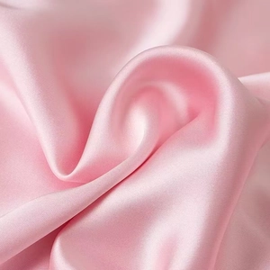 Detail of premium pink silk satin fabric with elegant drape and soft pearly luster finish