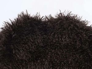 Detailed close-up of premium black faux fur texture with dense curly sheepskin-like wool