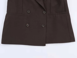 Macro detail of dark brown double-breasted blazer with textured fabric and marble buttons