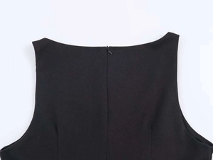 Detail shot of a black sleeveless top with a neat hidden back zipper and woven texture