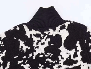 Close-up of ribbed stand collar and black white jacquard knit texture on the sweater