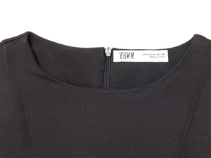 Close-up of black dress round neckline with metal zipper and size label detail