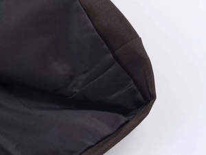 Detailed macro view showing heavy brown canvas fabric texture with smooth black lining